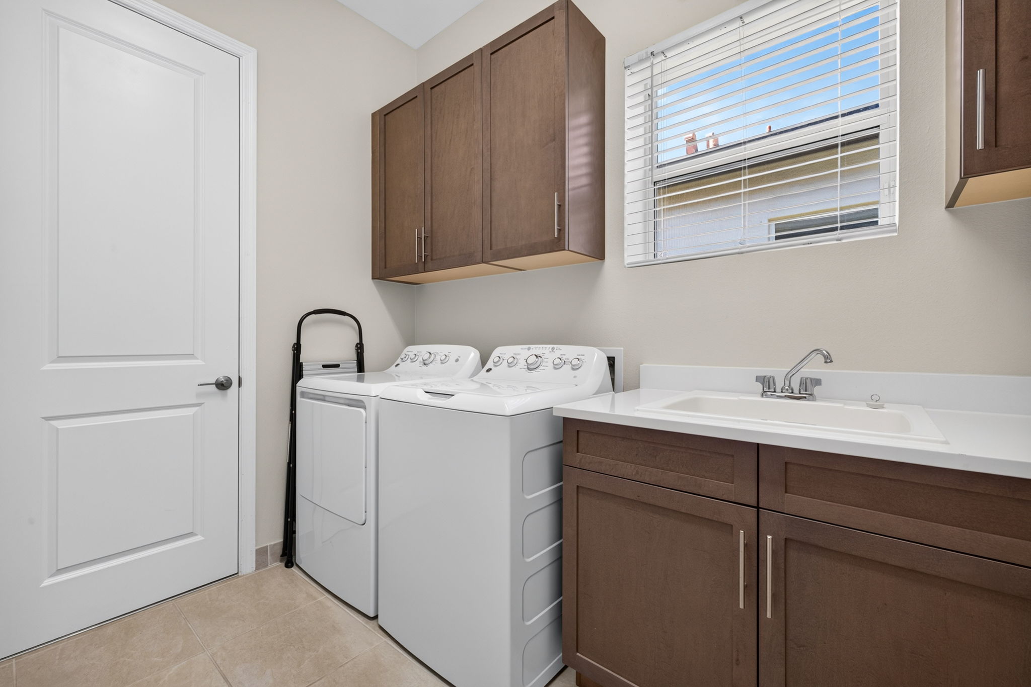 POCKET DOOR is a space saver! Built-in cabinets for extra storage plus laundry sink.