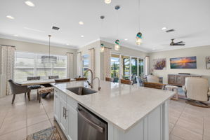 View from kitchen into great room, dining area and outside to take in the awesome lake view!