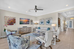 Tv, 2 pieces of art above sofa, sofa, 2 swivel coastal chairs, coffee table, lamps and 2 end tables will convet