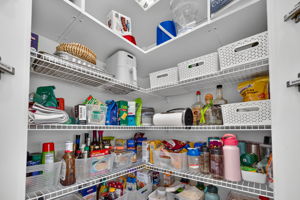 Notice the added two top shelves in this LARGE walk-in pantry! Lots of room for your Costco runs!
