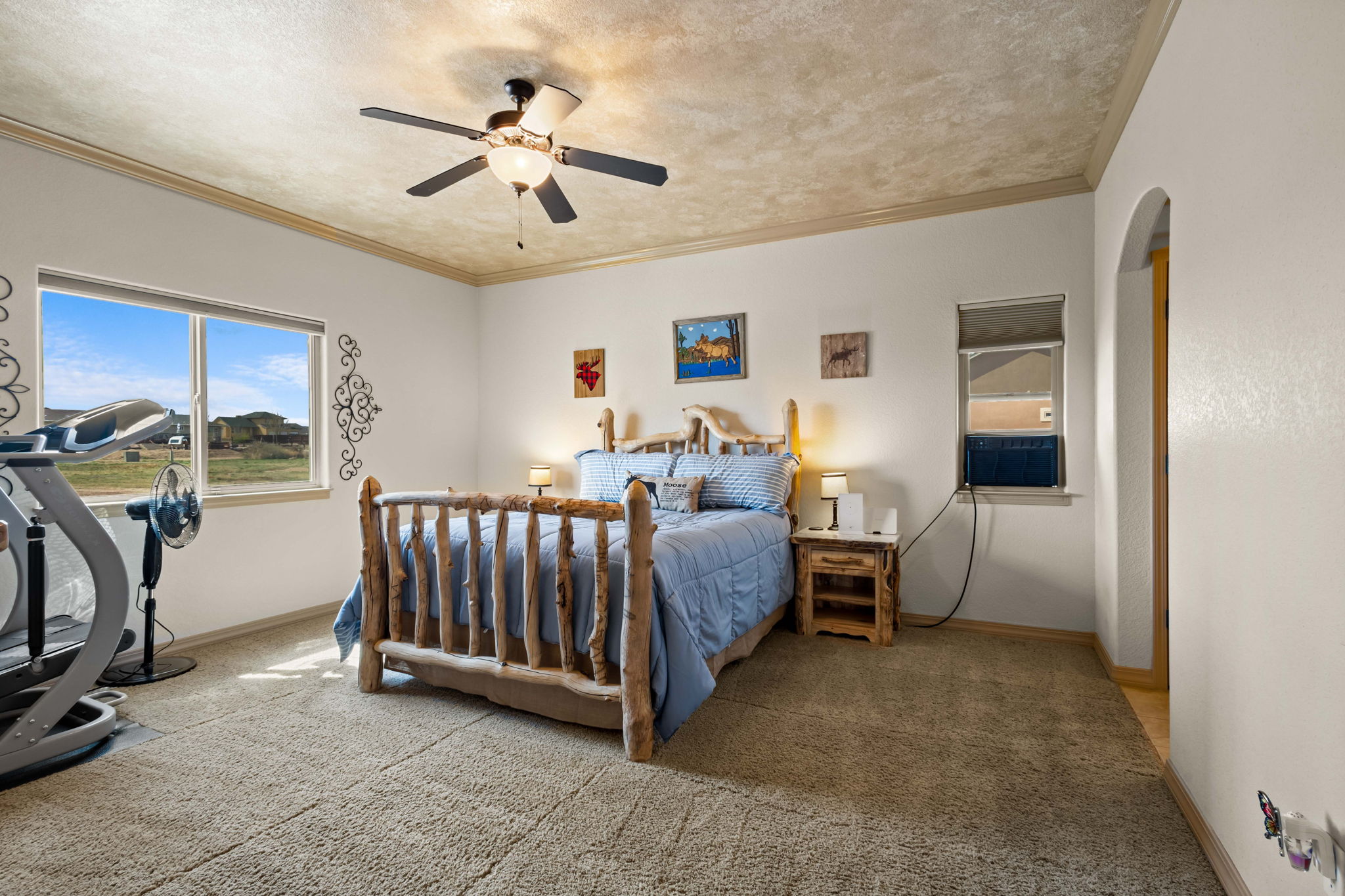 Primary Bedroom with Faux Painted ceiling adorned with crown molding.