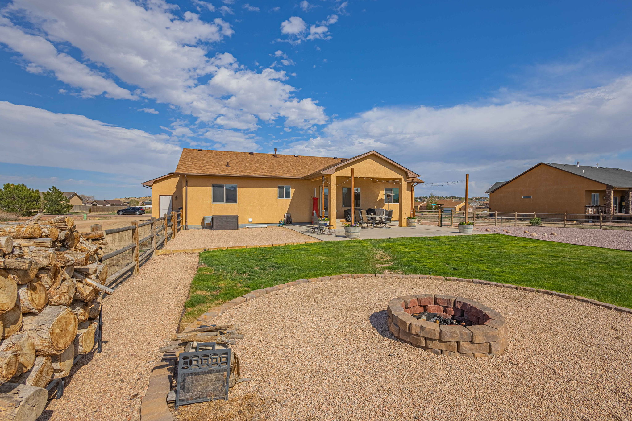 Fenced portion not only has grass but a fire pit, making time with friends and family memorable.