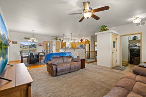 The living boasts ceiling fan, carpet, coat closet and owners entrance through the laundry room with drop zone.