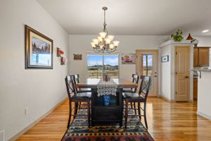 Walk-out Dining Room with Gleaming Hardwood Floors, Large Picture window and stunning chandelier
