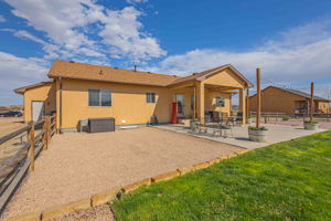 View of the backyard with Covered Patio and extended patio portion adding additional space for outdoor events.