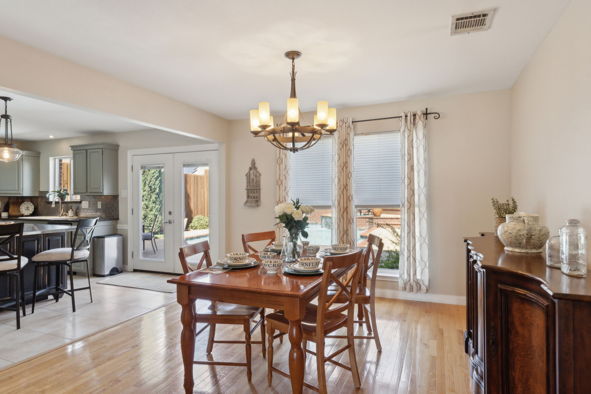 The Dining Area is perfect for family dinners or entertaining - the attractive lighting - warm wood flooring and spectacular views to the backyard pool area, make this room special!