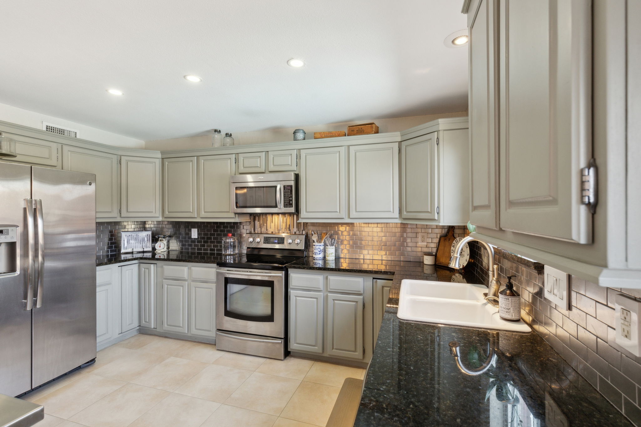 This view of the kitchen really shows off the latest colors of both the cabinets and the granite counters!  The specialty cabinets in the corners are an upgrade!