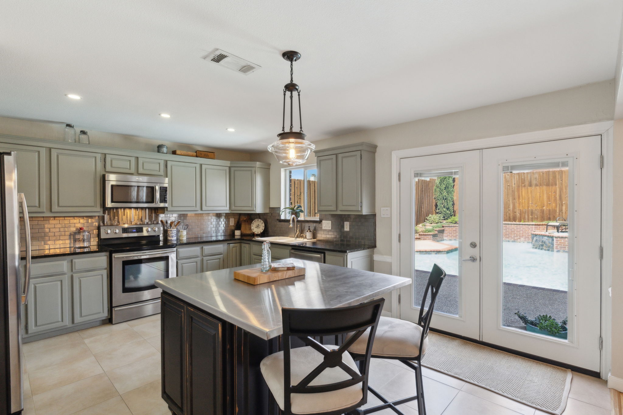 This "award winning" kitchen, with views of the backyard with the flowing waterfall and inviting deck area is stunning!