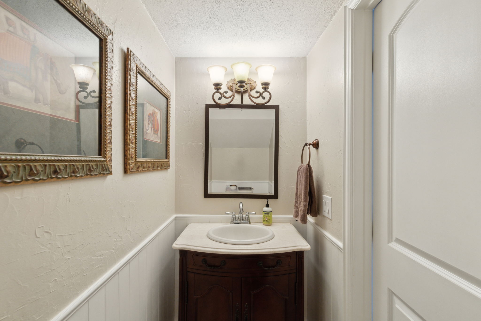 This lovely half bath is nestled away and yet so convenient for guests and family!