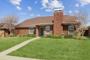 Lovely Landscaping and Fireplace add to the inviting drive up!