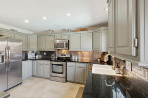 This view of the kitchen really shows off the latest colors of both the cabinets and the granite counters!  The specialty cabinets in the corners are an upgrade!