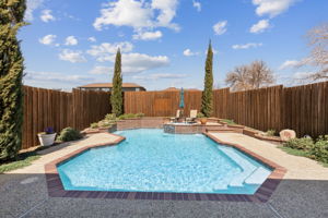WOW! Check out this AMAZING Pool - generous seating areas, water feature, and the landscaping adds the finishing touch!   All this and just in time for Summer fun!