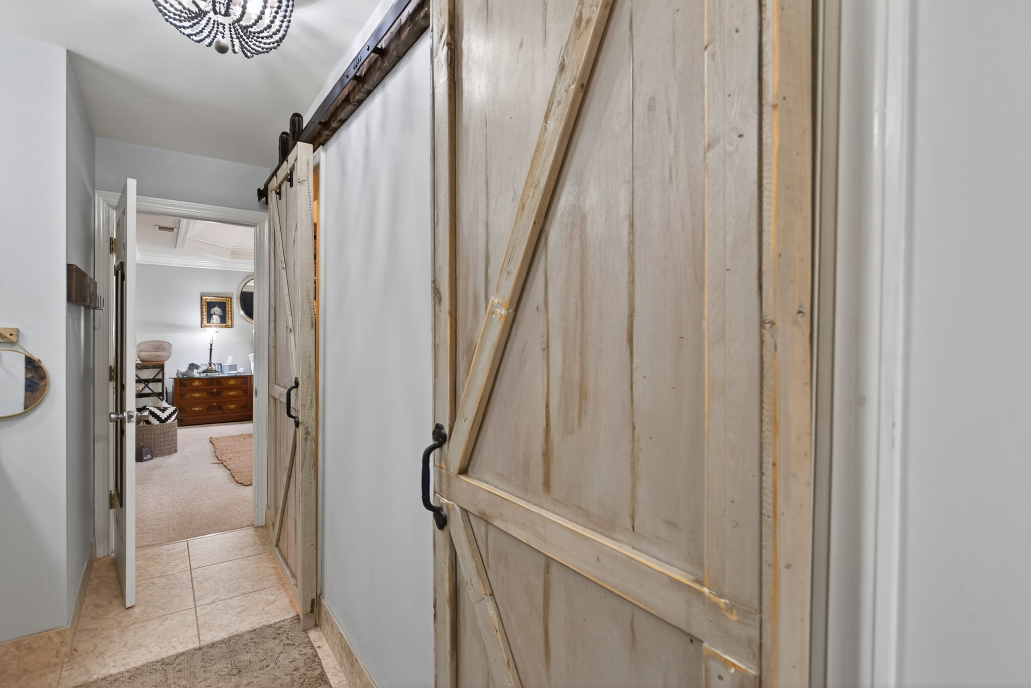 Barn doors open to double walk-in closets and serious style.