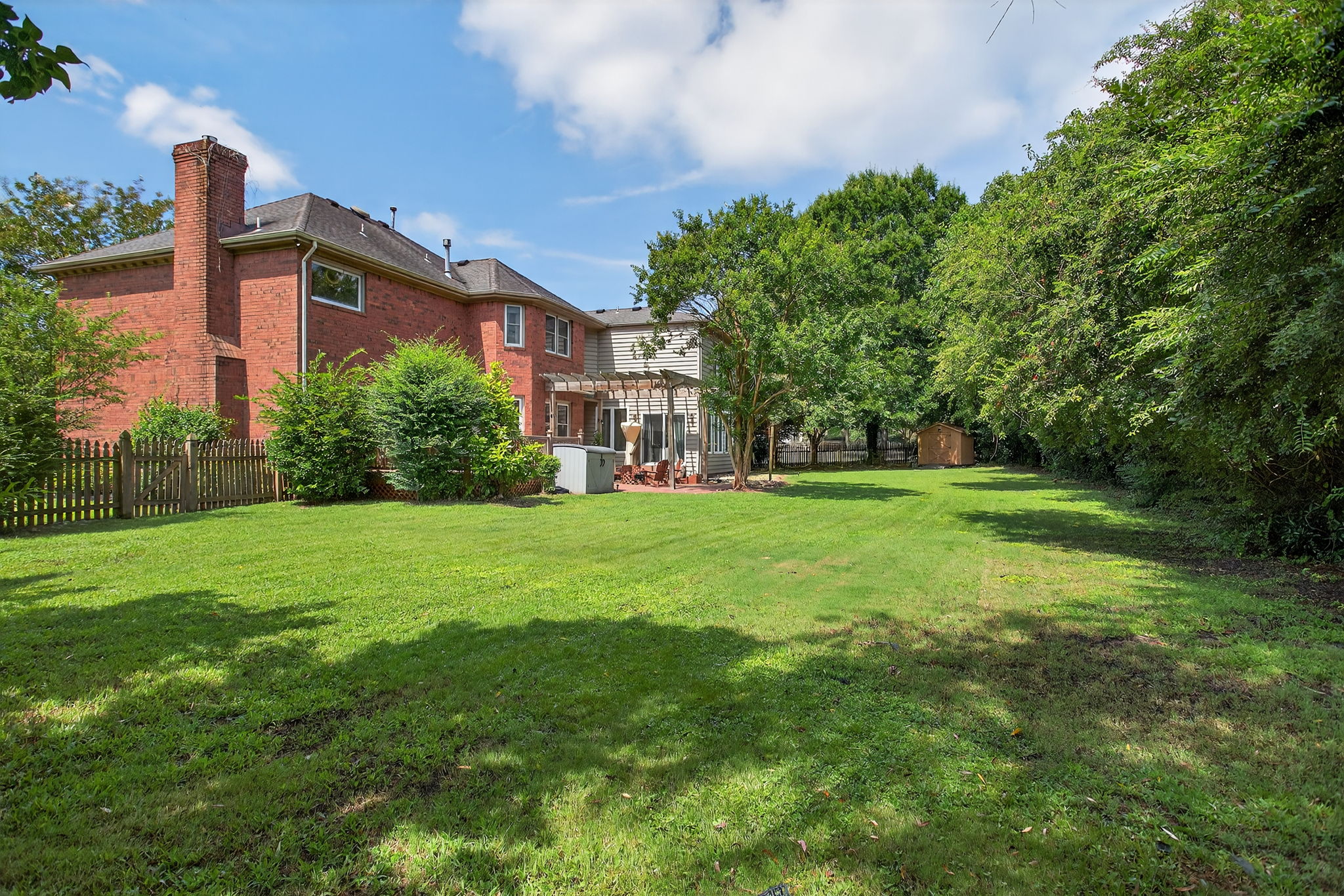 Expansive and private outdoor retreat—fully fenced with defined spaces for relaxation, entertaining, and play.