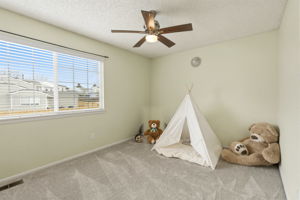2nd bedroom with walk in closet and ceiling fan