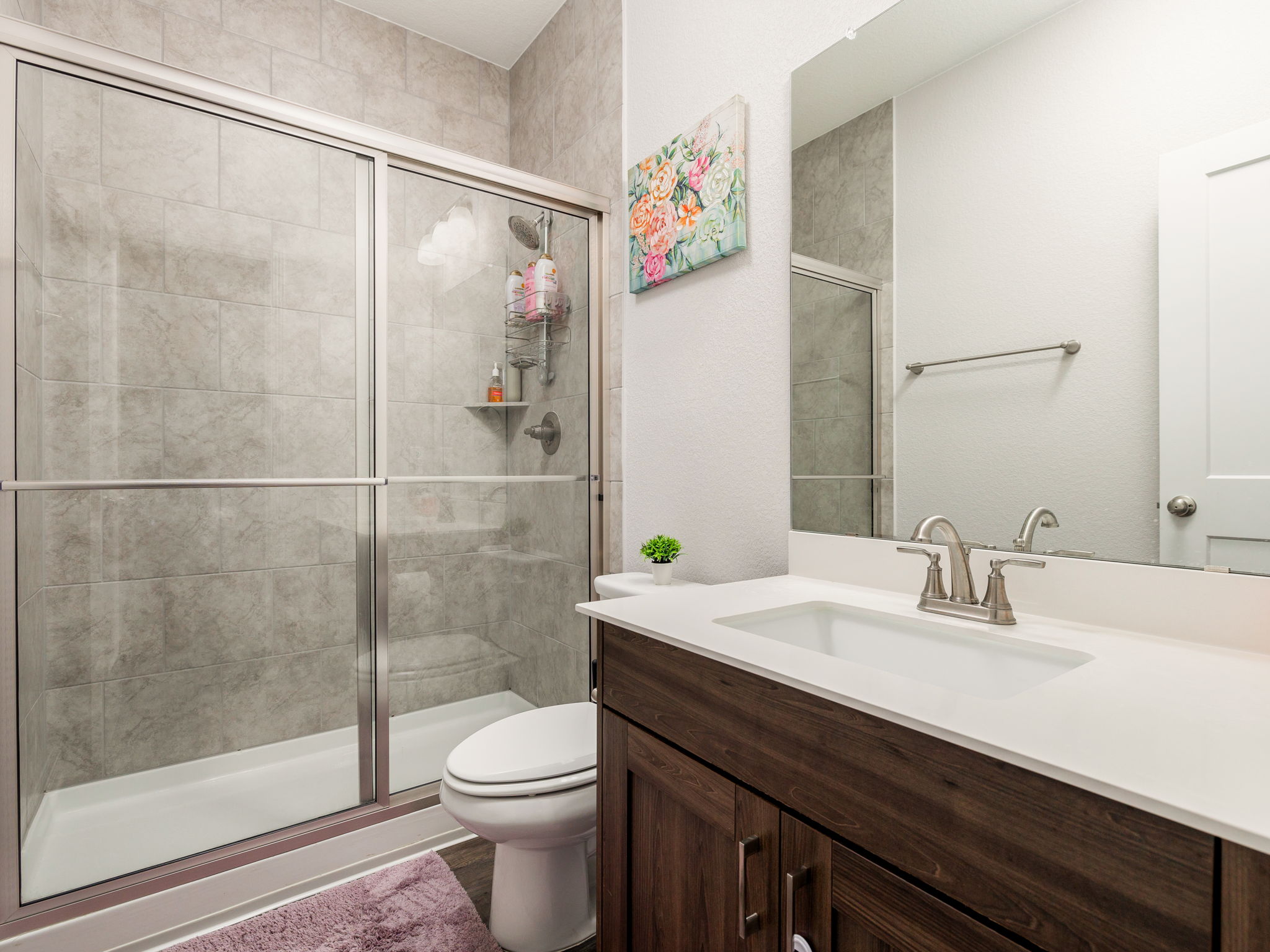 Walk in shower, floor to ceiling shower surround, and little extra counter top space...just in case its needed!