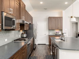 Shaker style cabinets with lots of built in stainless steal appliances!