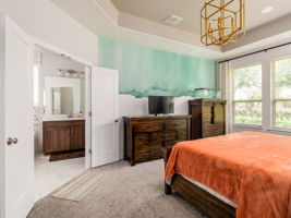 Plenty of natural light, custom wall paper artwork, and french doors leading into the bathroom!