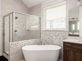Spa like bathroom with relaxing stand alone tub, oversized walk in shower surrounded by floor to ceiling tile!