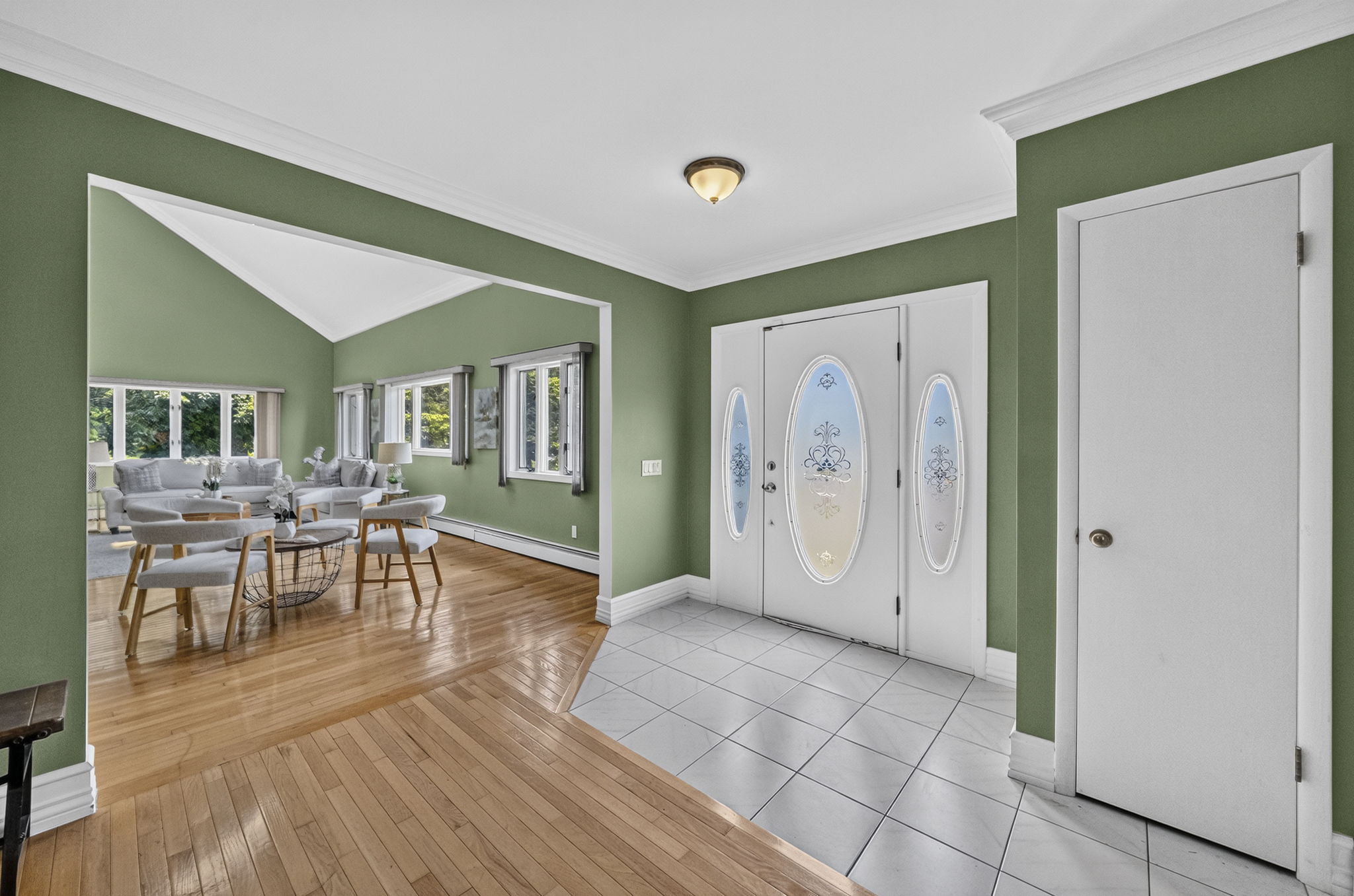 A warm and welcoming foyer leads to the spacious living room and an impressive great room filled with natural light from skylights set into the vaulted ceiling.