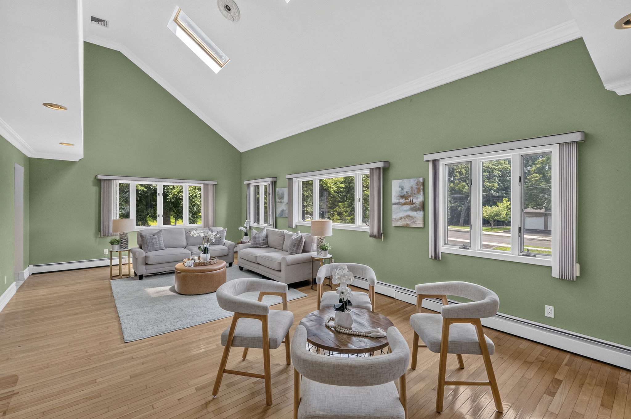 Great Room: A warm and welcoming foyer leads to the spacious living room and an impressive great room filled with natural light from skylights set into the vaulted ceiling.