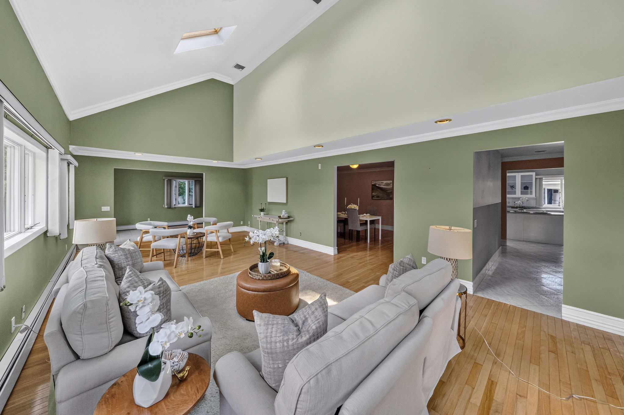 Great Room: A warm and welcoming foyer leads to the spacious living room and an impressive great room filled with natural light from skylights set into the vaulted ceiling.