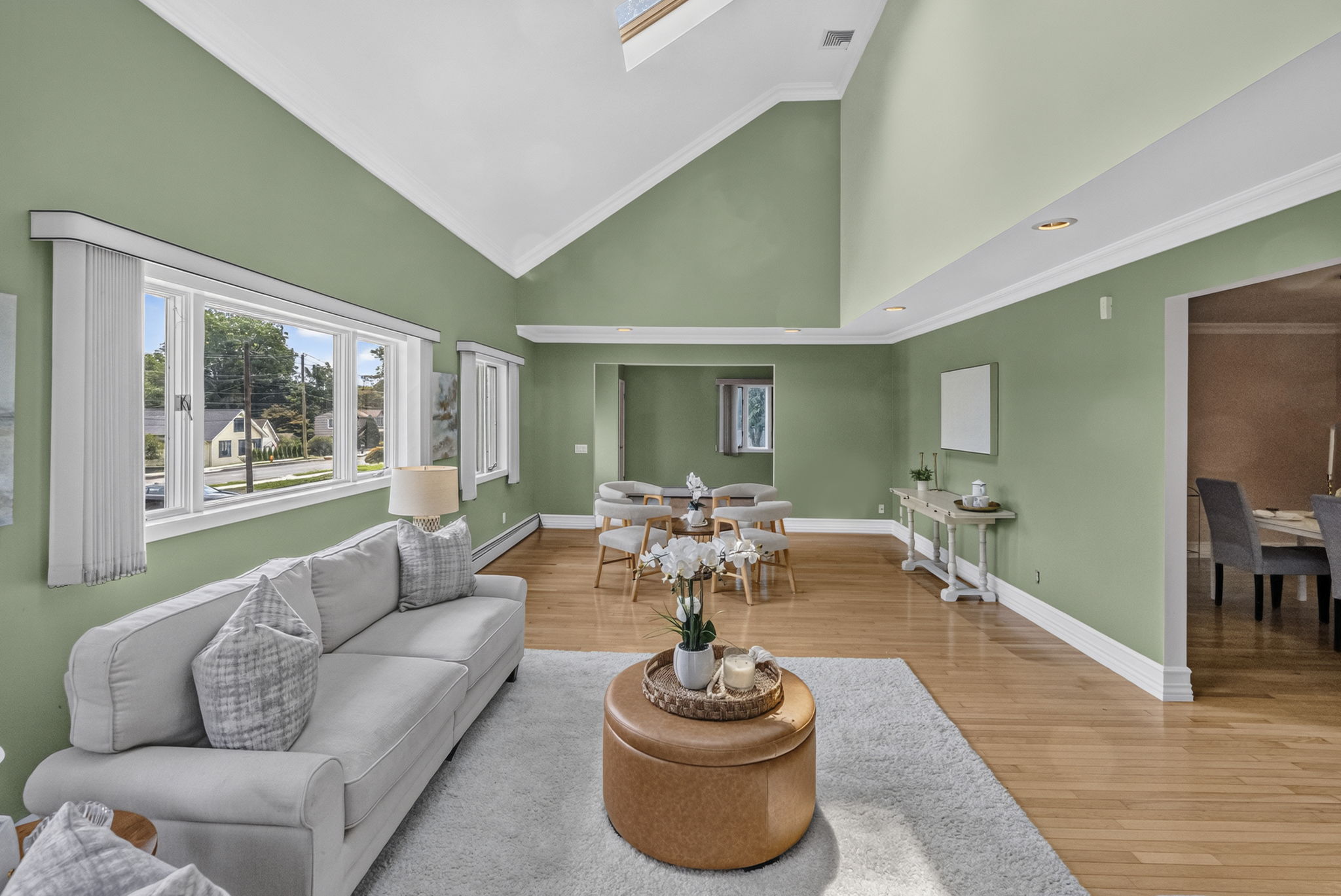 Great Room: A warm and welcoming foyer leads to the spacious living room and an impressive great room filled with natural light from skylights set into the vaulted ceiling.
