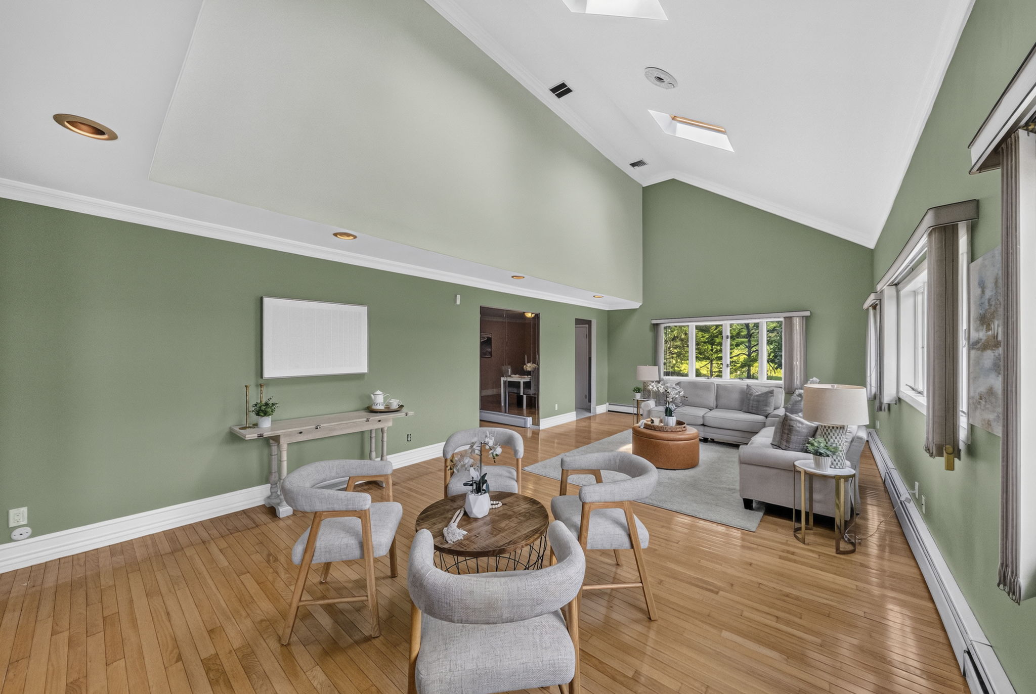 Great Room: A warm and welcoming foyer leads to the spacious living room and an impressive great room filled with natural light from skylights set into the vaulted ceiling.