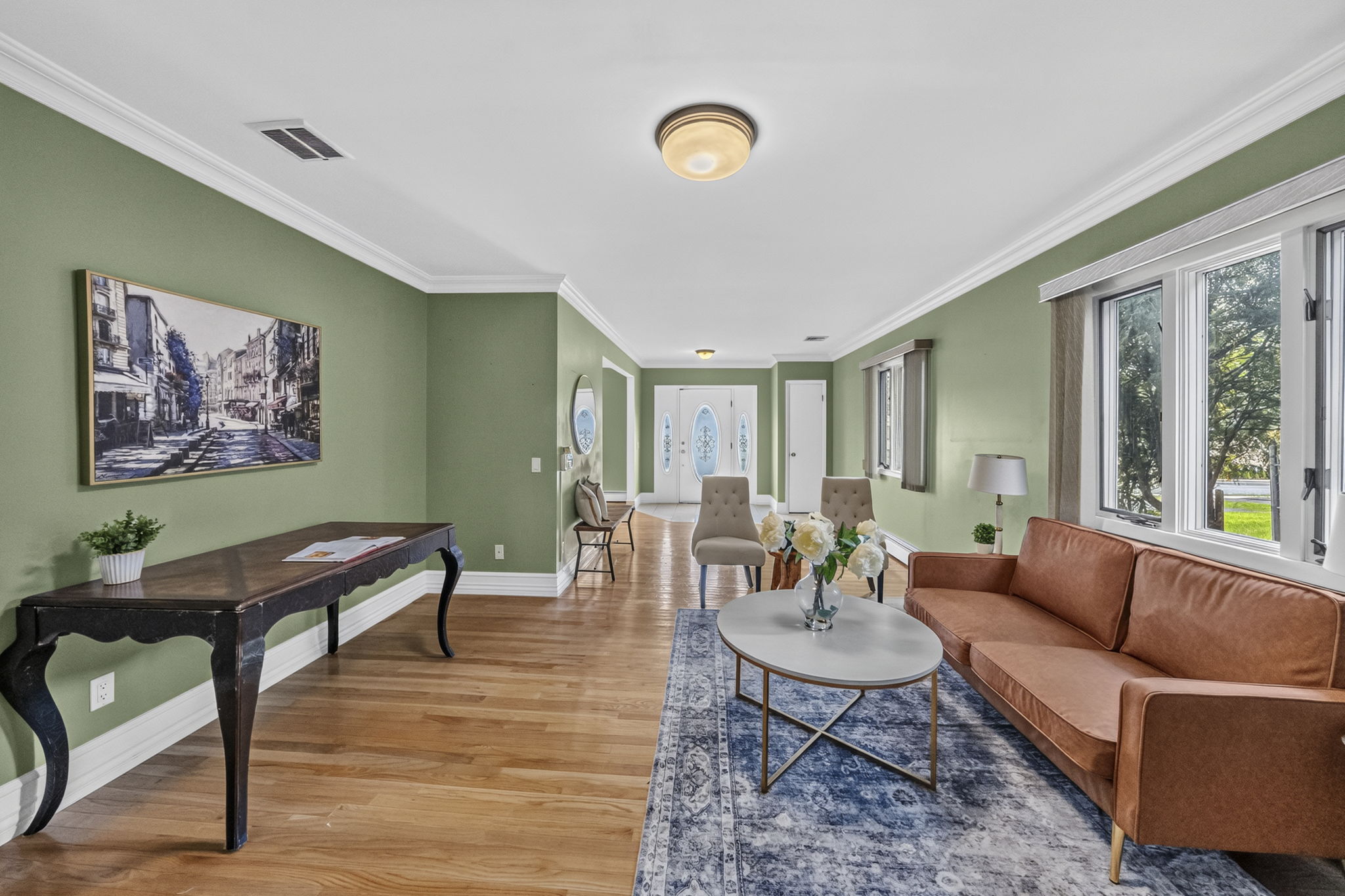 Living Room: A warm and welcoming foyer leads to the spacious living room and an impressive great room filled with natural light from skylights set into the vaulted ceiling.
