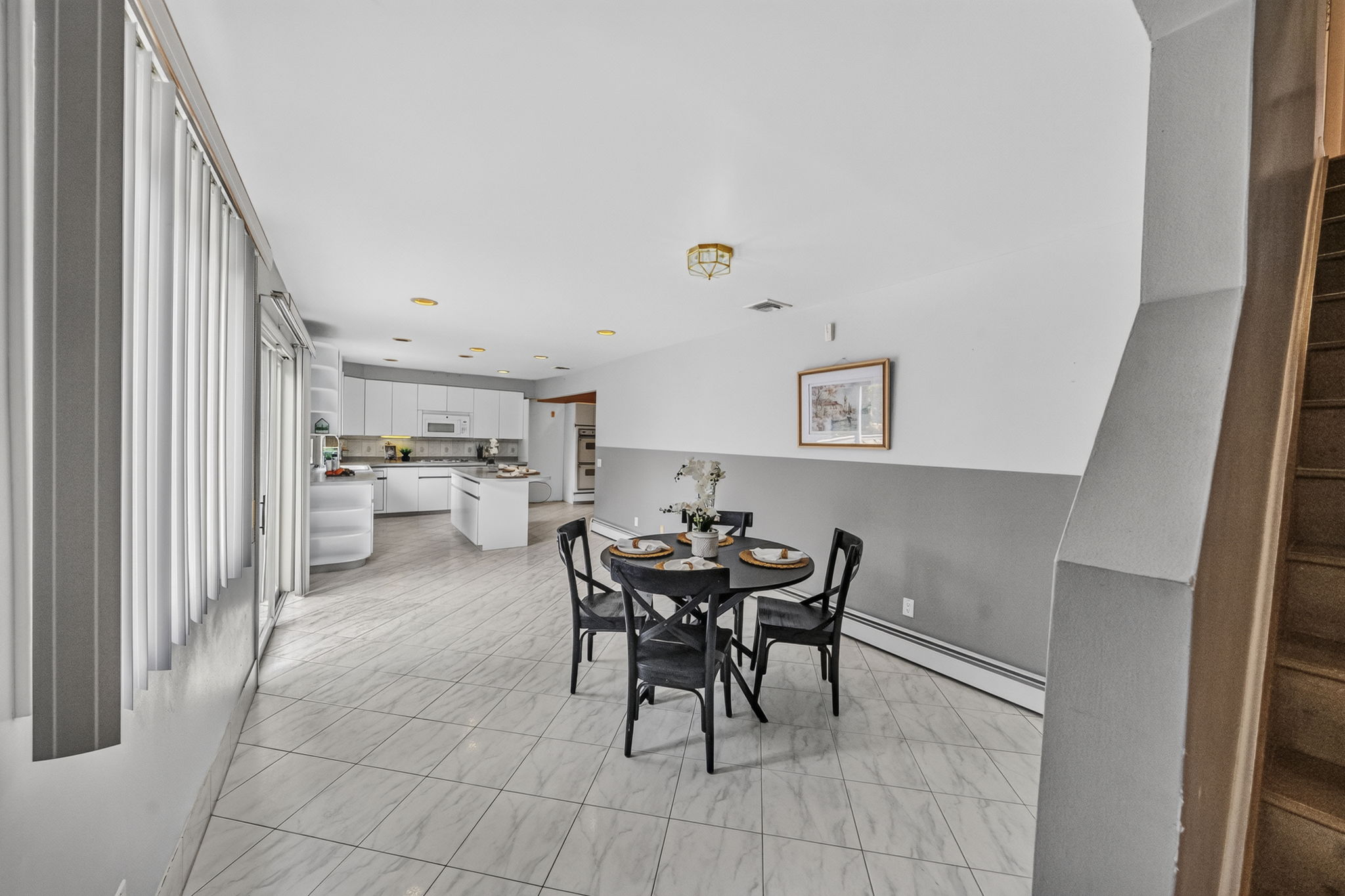 Eat in Kitchen: Designed for gathering, the eat-in kitchen features white lacquer cabinetry, a pantry, dedicated coffee bar and large center island with seating for up to six. A separate dining area provides additional seating and creates an easy flow between cooking, dining and entertaining.