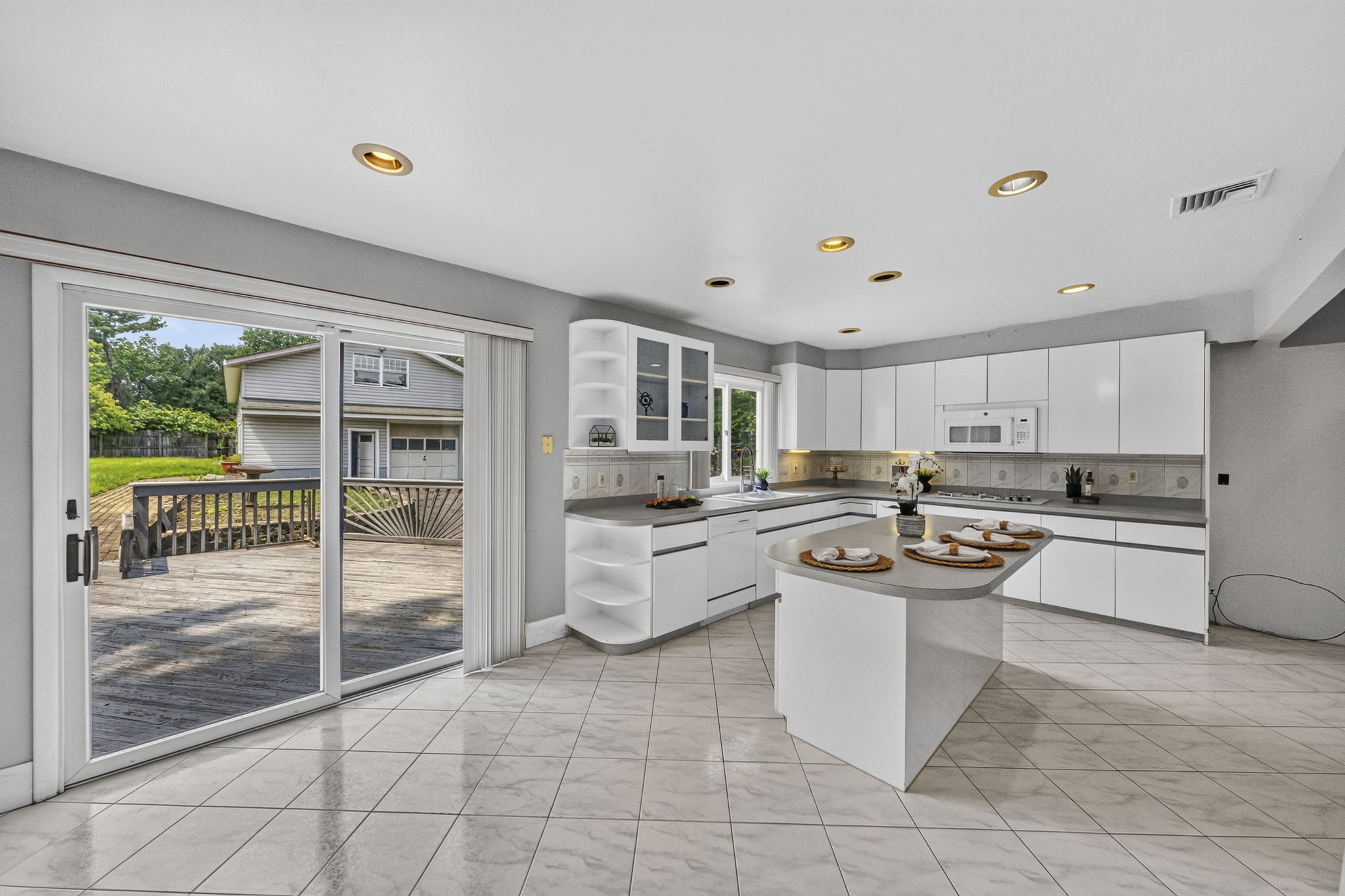 Eat in Kitchen: Designed for gathering, the eat-in kitchen features white lacquer cabinetry, a pantry, dedicated coffee bar and large center island with seating for up to six. A separate dining area provides additional seating and creates an easy flow between cooking, dining and entertaining.