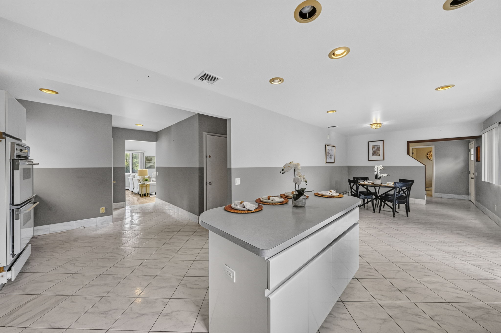 Eat in Kitchen: Designed for gathering, the eat-in kitchen features white lacquer cabinetry, a pantry, dedicated coffee bar and large center island with seating for up to six. A separate dining area provides additional seating and creates an easy flow between cooking, dining and entertaining.