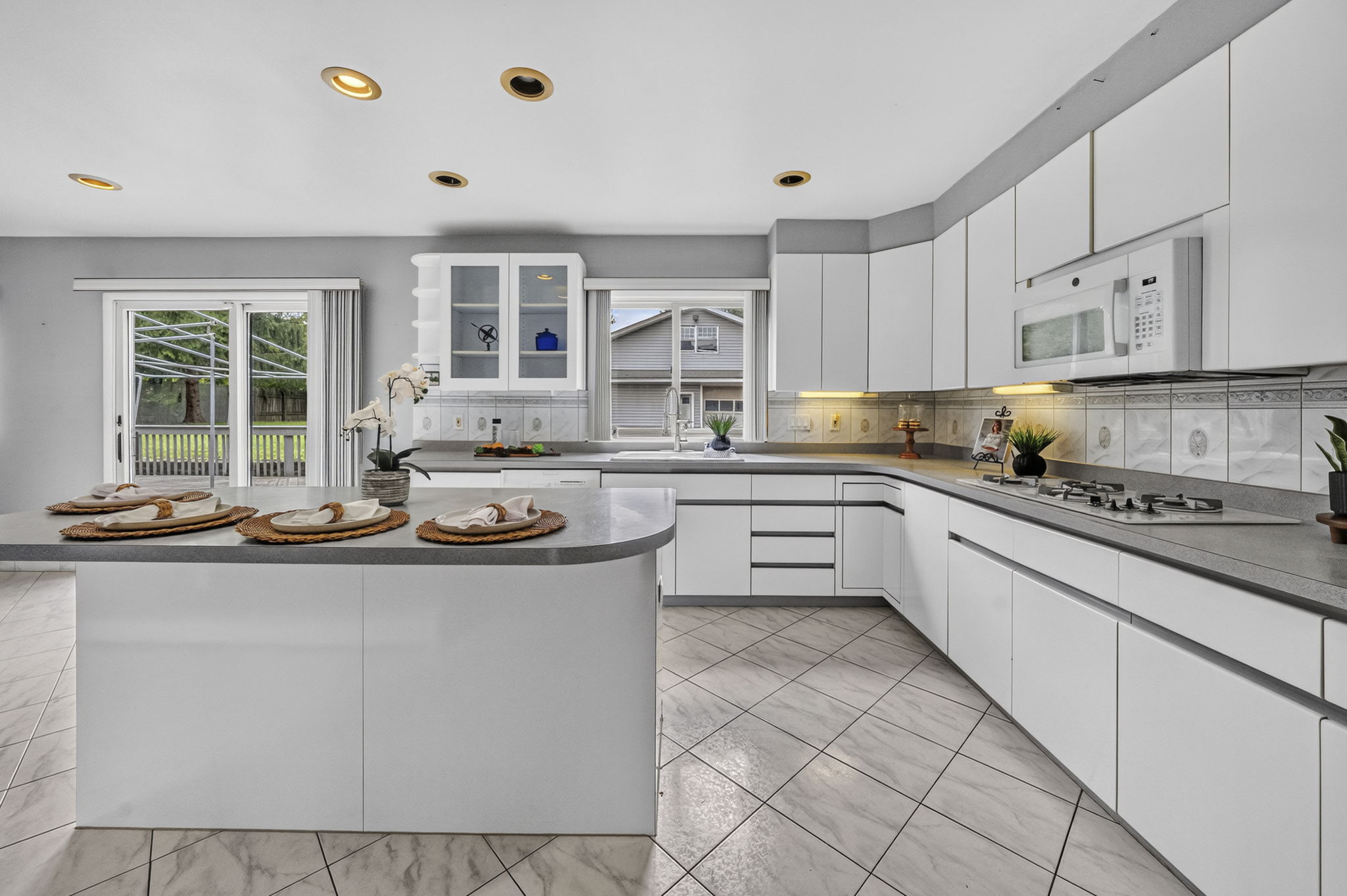 Eat in Kitchen: Designed for gathering, the eat-in kitchen features white lacquer cabinetry, a pantry, dedicated coffee bar and large center island with seating for up to six. A separate dining area provides additional seating and creates an easy flow between cooking, dining and entertaining.