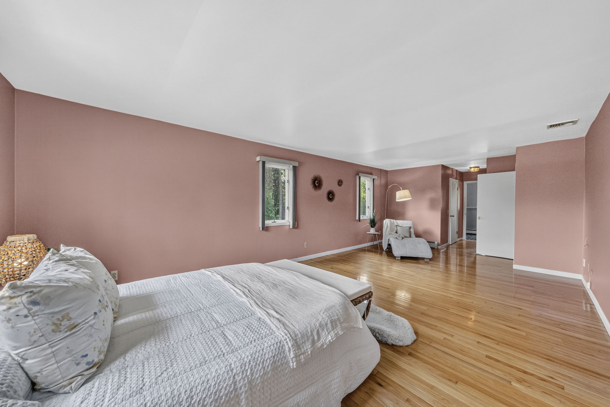 Primary Bedroom En Suite: Upstairs, the exceptionally spacious primary suite has room for a king-size bed and a comfortable sitting area. Storage is abundant with a walk-in closet and two additional closets, while the private primary bath offers generous space.