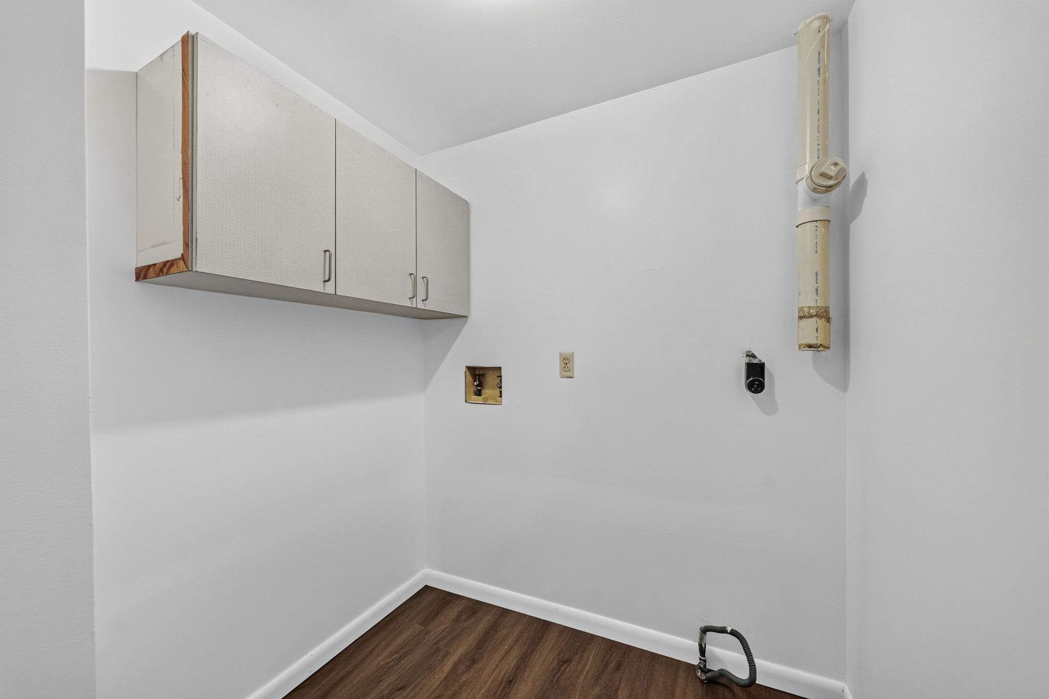 A freshly painted second-floor laundry room keeps daily tasks conveniently close to the bedrooms. Mostly hardwood floors run throughout the home.