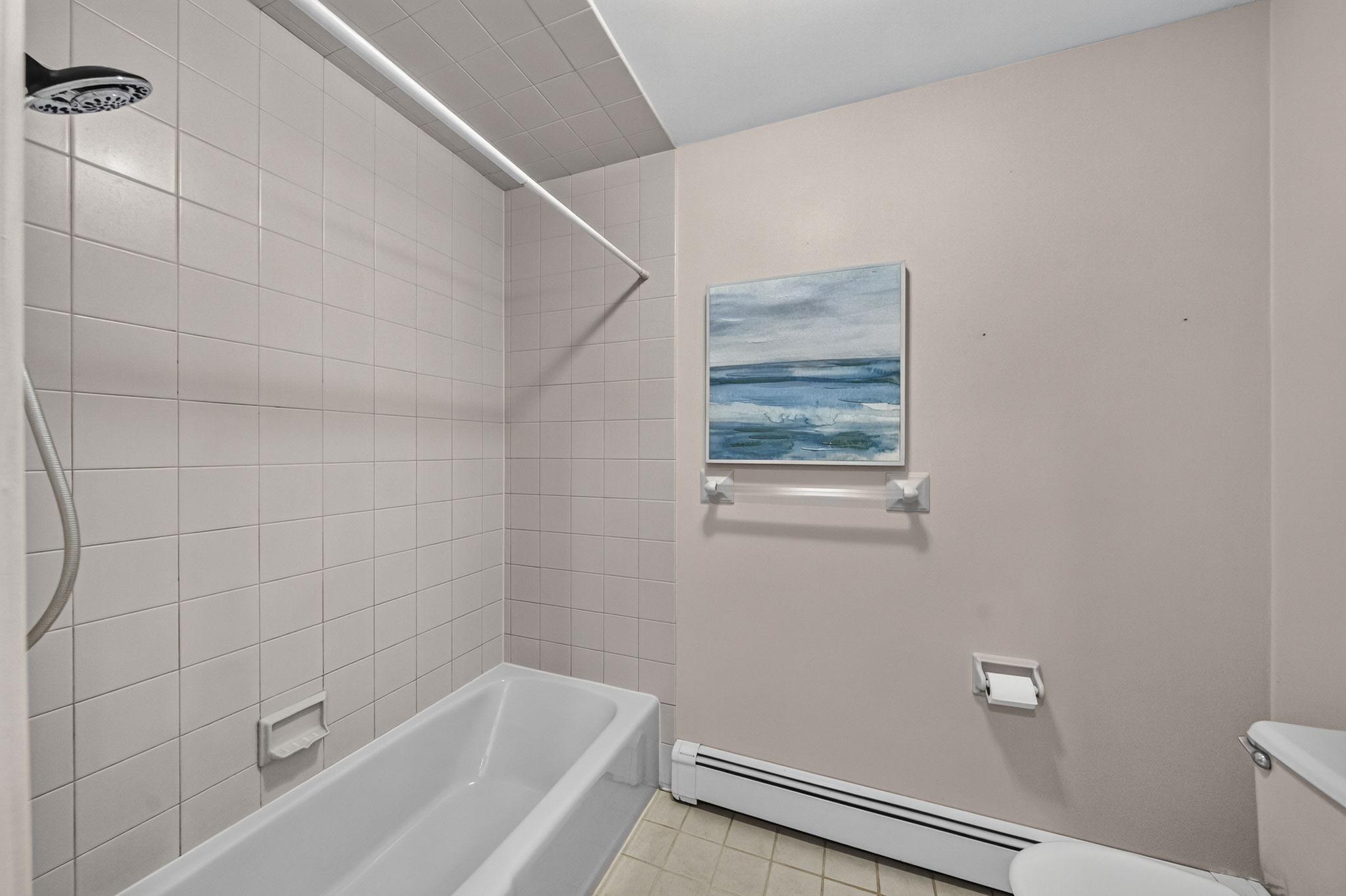 Second floor main bath featuring dual sinks and a separate shower and toilet area. A freshly painted second-floor laundry room keeps daily tasks conveniently close to the bedrooms.