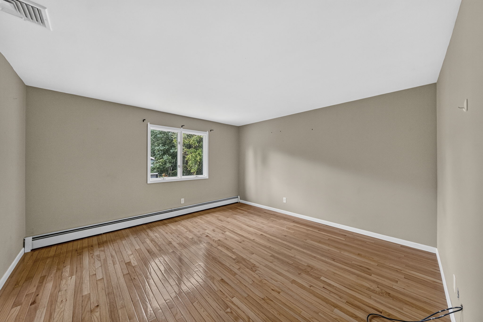 Bedroom #3: Three additional well-sized bedrooms share a main bath featuring dual sinks and a separate shower and toilet area. A freshly painted second-floor laundry room keeps daily tasks conveniently close to the bedrooms. Mostly hardwood floors run throughout the home.