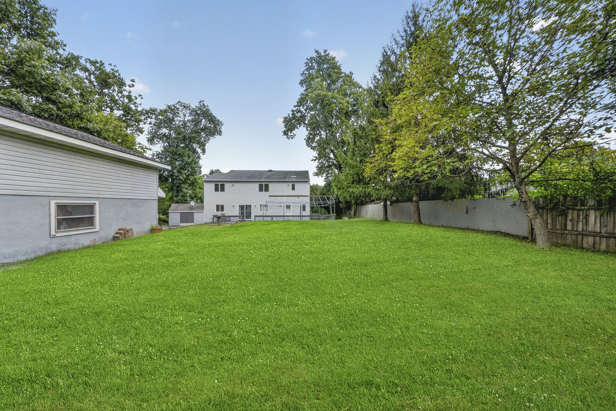 Step outside to an oversized wood deck overlooking the expansive backyard , larger than others, with almost one acre.