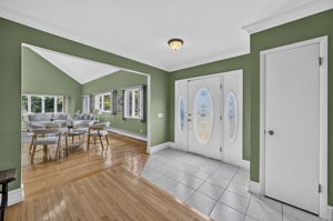 A warm and welcoming foyer leads to the spacious living room and an impressive great room filled with natural light from skylights set into the vaulted ceiling.