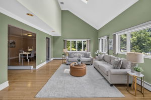 Great Room: A warm and welcoming foyer leads to the spacious living room and an impressive great room filled with natural light from skylights set into the vaulted ceiling.