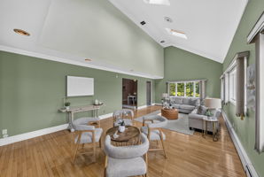 Great Room: A warm and welcoming foyer leads to the spacious living room and an impressive great room filled with natural light from skylights set into the vaulted ceiling.