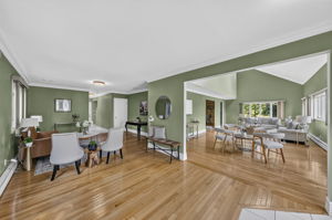 A warm and welcoming foyer leads to the spacious living room and an impressive great room filled with natural light from skylights set into the vaulted ceiling.