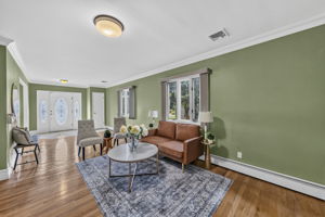 Living Room: A warm and welcoming foyer leads to the spacious living room and an impressive great room filled with natural light from skylights set into the vaulted ceiling.