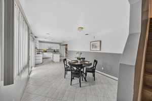 Eat in Kitchen: Designed for gathering, the eat-in kitchen features white lacquer cabinetry, a pantry, dedicated coffee bar and large center island with seating for up to six. A separate dining area provides additional seating and creates an easy flow between cooking, dining and entertaining.