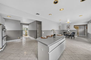 Eat in Kitchen: Designed for gathering, the eat-in kitchen features white lacquer cabinetry, a pantry, dedicated coffee bar and large center island with seating for up to six. A separate dining area provides additional seating and creates an easy flow between cooking, dining and entertaining.