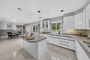 Eat in Kitchen: Designed for gathering, the eat-in kitchen features white lacquer cabinetry, a pantry, dedicated coffee bar and large center island with seating for up to six. A separate dining area provides additional seating and creates an easy flow between cooking, dining and entertaining.