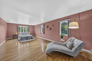 Primary Bedroom En Suite: Upstairs, the exceptionally spacious primary suite has room for a king-size bed and a comfortable sitting area. Storage is abundant with a walk-in closet and two additional closets, while the private primary bath offers generous space.