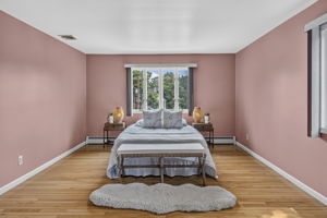 Primary Bedroom En Suite: Upstairs, the exceptionally spacious primary suite has room for a king-size bed and a comfortable sitting area. Storage is abundant with a walk-in closet and two additional closets, while the private primary bath offers generous space.