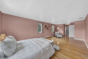 Primary Bedroom En Suite: Upstairs, the exceptionally spacious primary suite has room for a king-size bed and a comfortable sitting area. Storage is abundant with a walk-in closet and two additional closets, while the private primary bath offers generous space.
