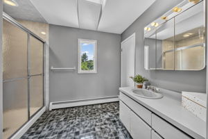 Primary Bedroom En Suite: Upstairs, the exceptionally spacious primary suite has room for a king-size bed and a comfortable sitting area. Storage is abundant with a walk-in closet and two additional closets, while the private primary bath offers generous space.